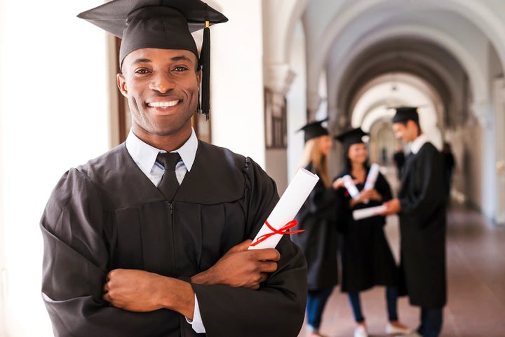 college graduate holding his diploma | LaFontaine Subaru in Commerce Township MI