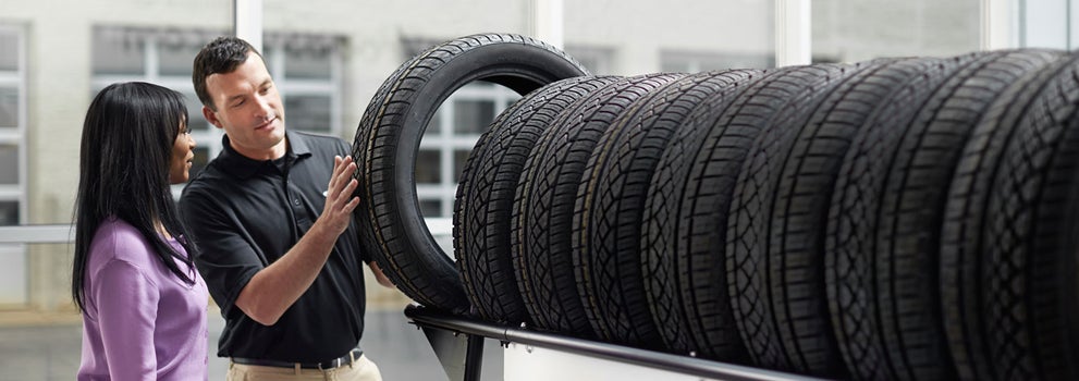 Subaru service representative showing customer a tire. | LaFontaine Subaru in Commerce Township MI