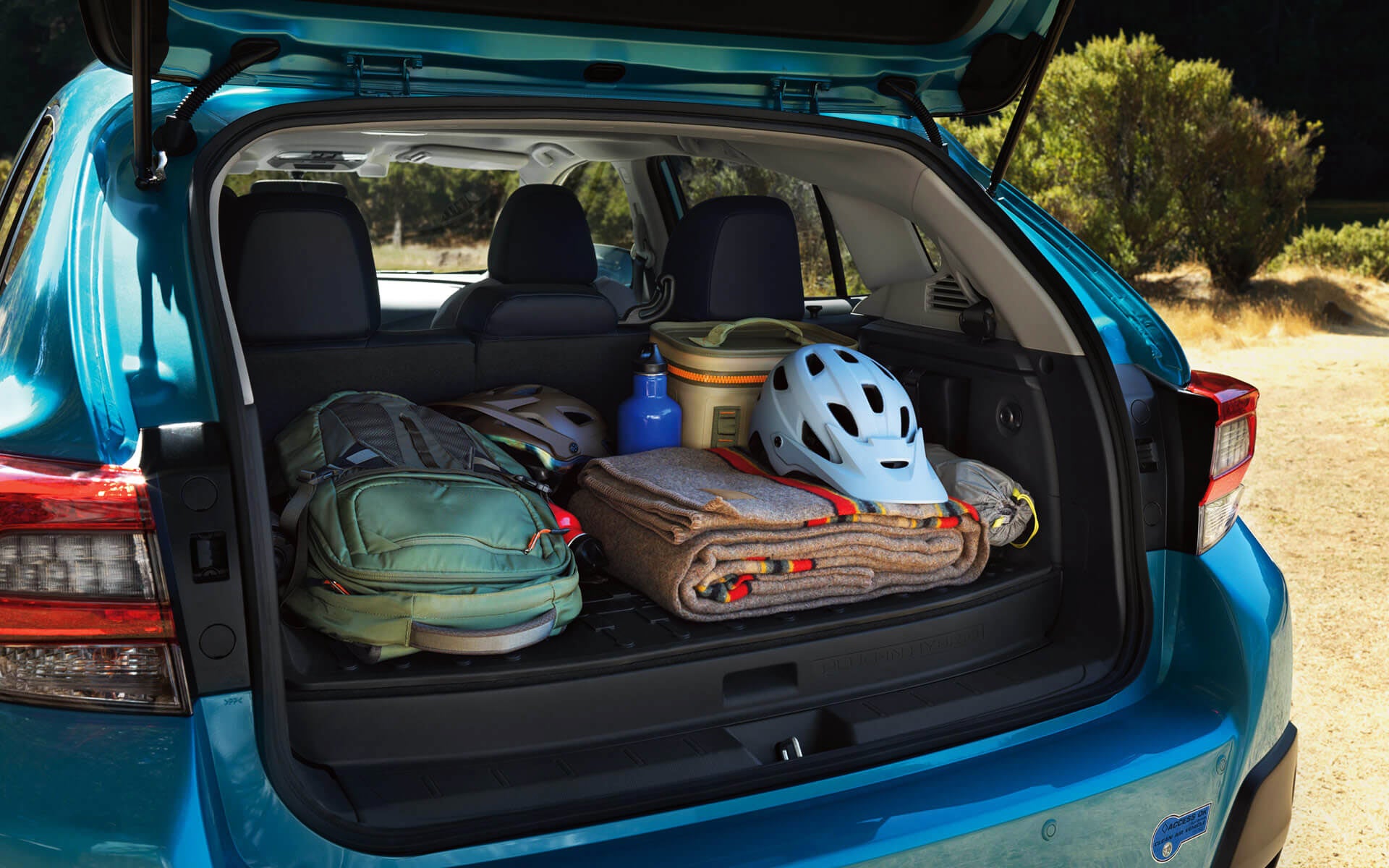 A backpack, blanket, and bike helmet in the rear cargo area of a Crosstrek Hybrid | LaFontaine Subaru in Commerce Township MI