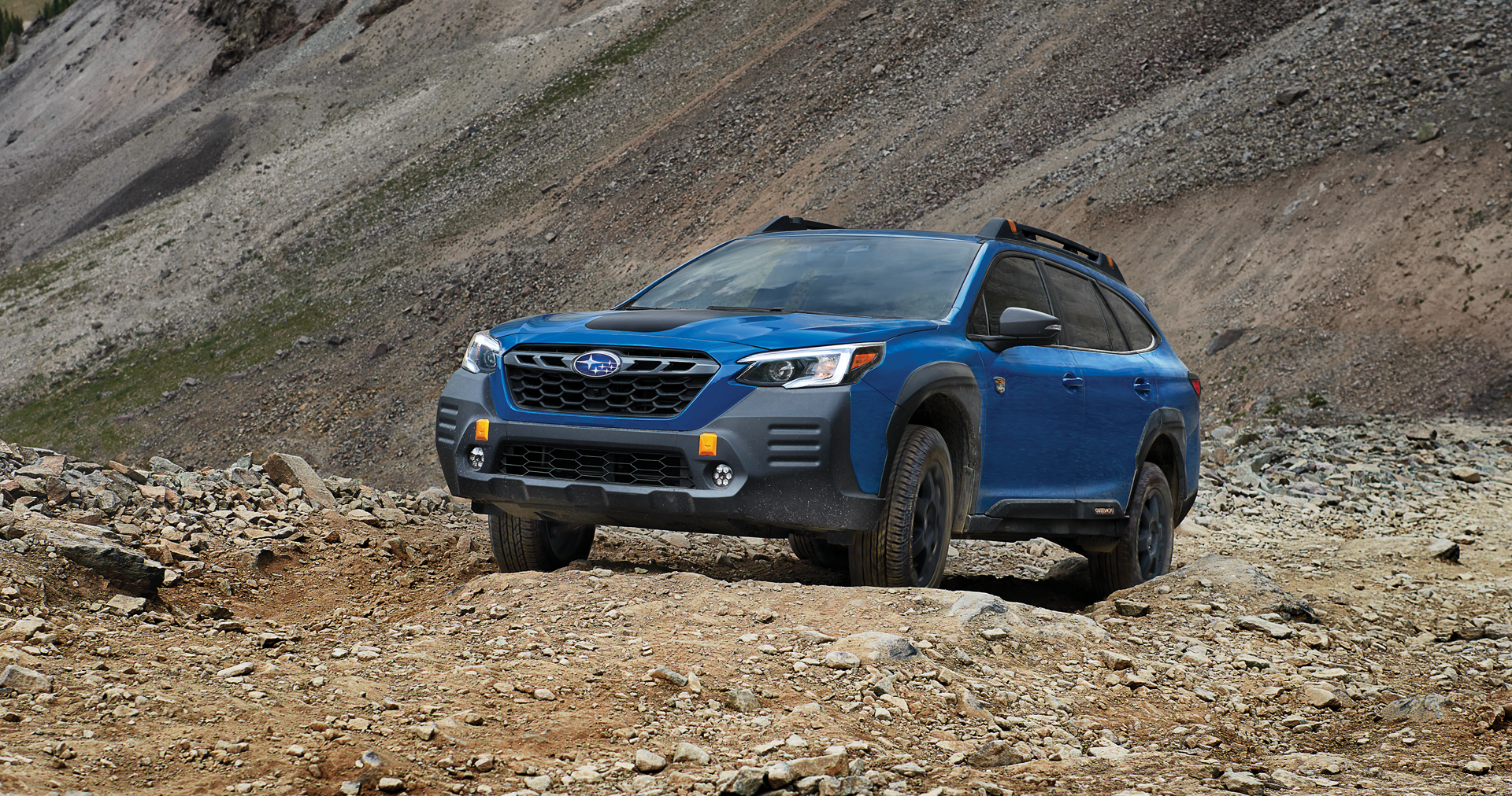 A 2023 Outback Wilderness driving on a trail in the mountains. | LaFontaine Subaru in Commerce Township MI