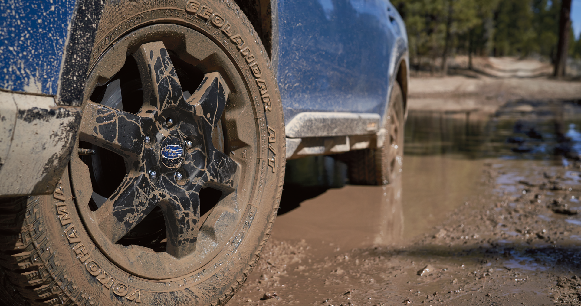 A close-up of the 17-inch off-road wheels and all-terrain Yokohama GEOLANDAR® tires on the 2023 Outback Wilderness. | LaFontaine Subaru in Commerce Township MI