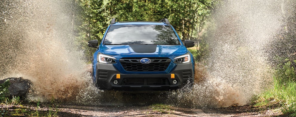 A 2023 Outback Wilderness driving on a muddy trail. | LaFontaine Subaru in Commerce Township MI