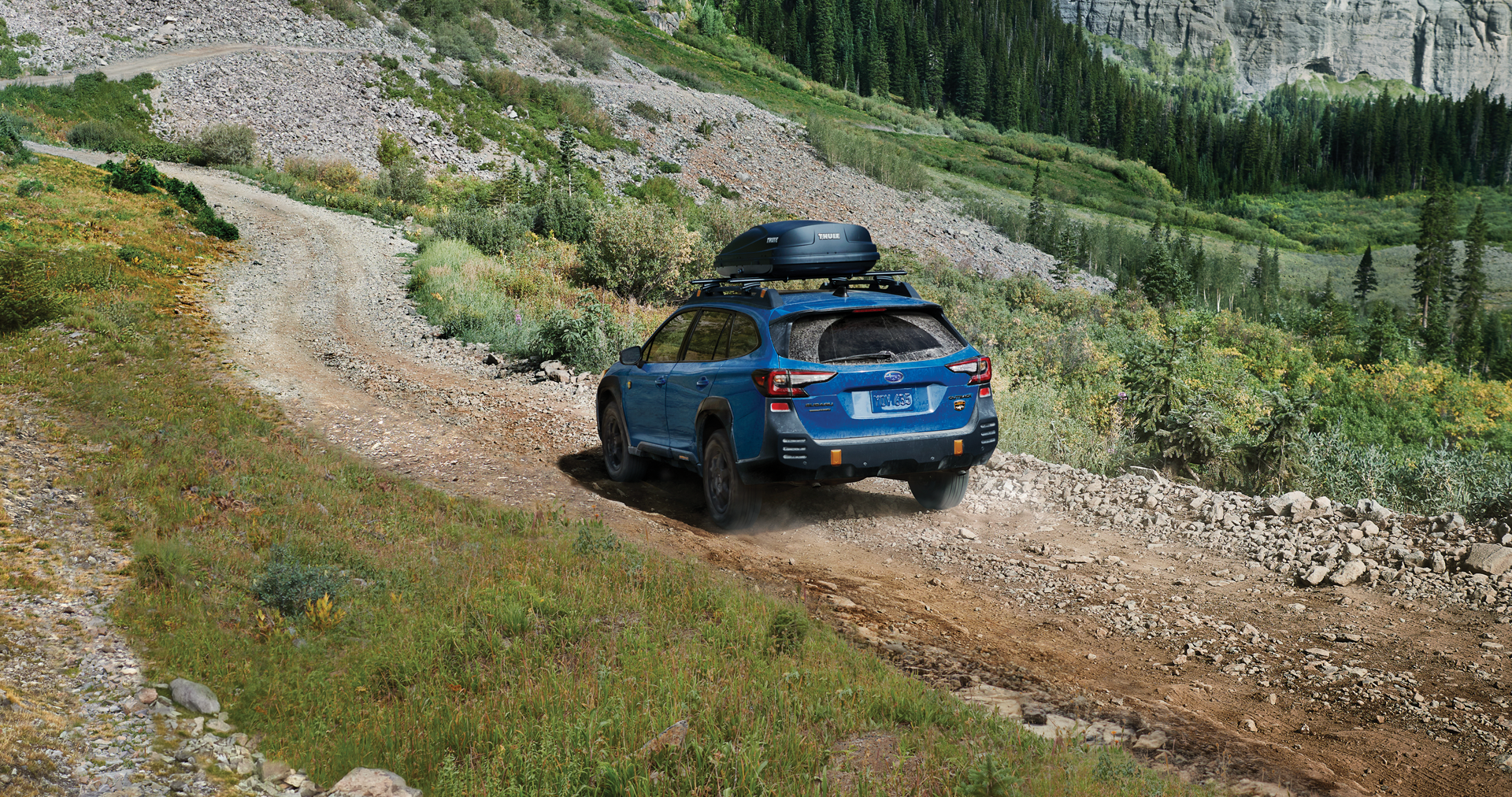 A 2023 Outback Wilderness driving on a trail in the mountains. | LaFontaine Subaru in Commerce Township MI